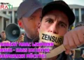 Fotorealistisches Porträt von Robert Marc Lehmann, der auf einer Straßenkundgebung in ein Megafon spricht, ein Quarkbällchen in der Hand hält und Protestschilder mit den Worten „Zensur“, Hass und Hetze im Hintergrund trägt.