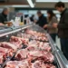 Fleischtheke in einem Supermarkt mit anonym verpacktem Schweinefleisch ohne erkennbare Informationen als Symbol für die verschobene Kennzeichnungspflicht Schweinefleisch