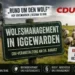 Wolfsmanagement in Iggewarden mit Wolf, Schafherde, Deichlandschaft und Hinweis auf die CDU-Veranstaltung „Rund um den Wolf“.