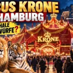 Circus Krone Hamburg mit Löwe und Tiger vor dem beleuchteten Zirkuszelt sowie protestierenden Tierschutzaktivisten.