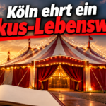 KI-generiertes Symbolbild zur Ehrung für Bernhard Paul: beleuchtetes Zirkuszelt im Abendlicht, offenes Buch und Überschrift „Köln ehrt ein Zirkus-Lebenswerk“.